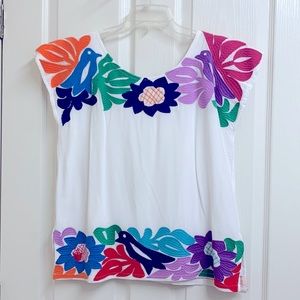 J.marie white top with multi color embroidery around top, bottom & back size M